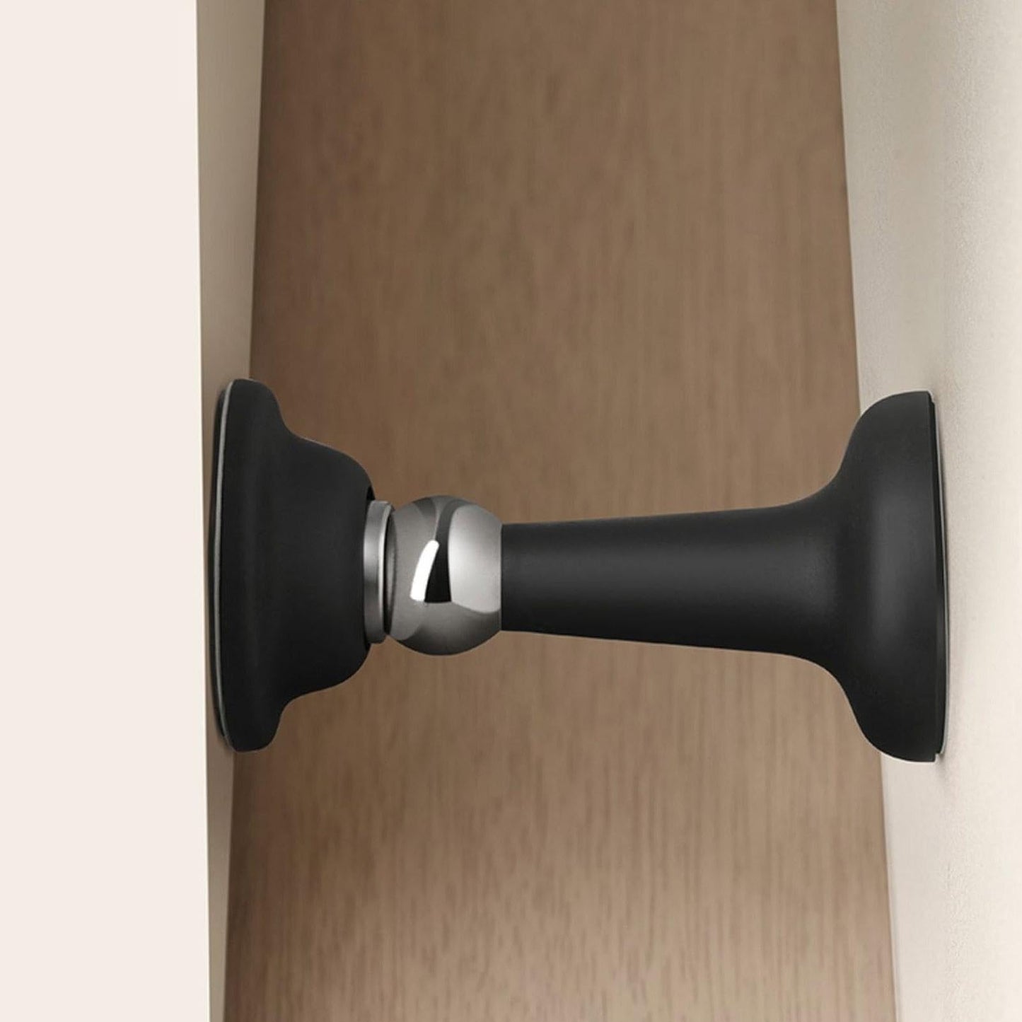 Black door stopper on a wooden door