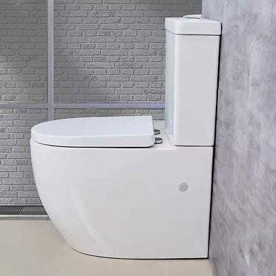 White toilet in a bathroom with tiled walls