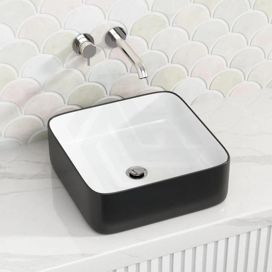 Black rectangular sink with white interior on a bathroom counter 