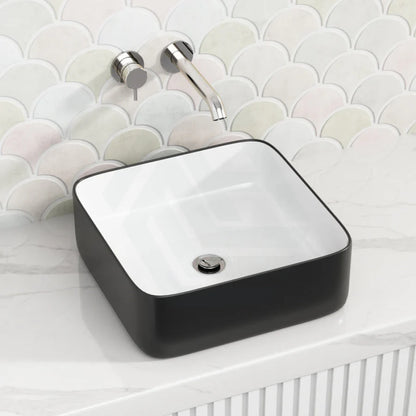 Black rectangular sink with white interior on a bathroom counter 